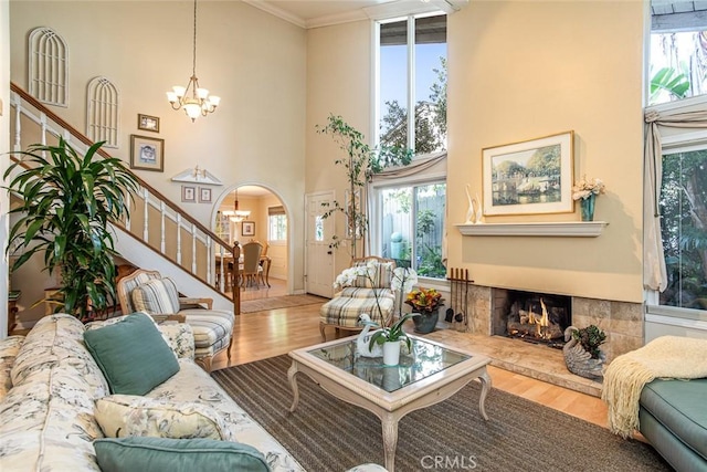 22435 Silver Spur, Lake Forest, CA 92630 - living area with stairs, wood finished floors, a notable chandelier, and a tile fireplace