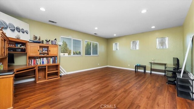 unfurnished room with recessed lighting, plenty of natural light, dark wood-style flooring, and visible vents