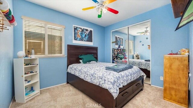 bedroom featuring baseboards, light colored carpet, and multiple windows