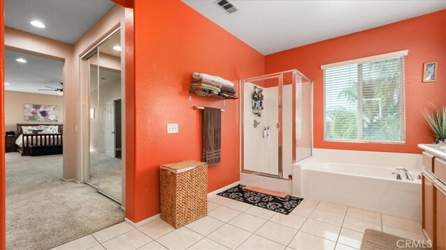 bathroom featuring visible vents, tile patterned flooring, a garden tub, ceiling fan, and a shower stall