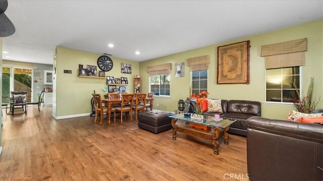 living area with baseboards, recessed lighting, and wood finished floors