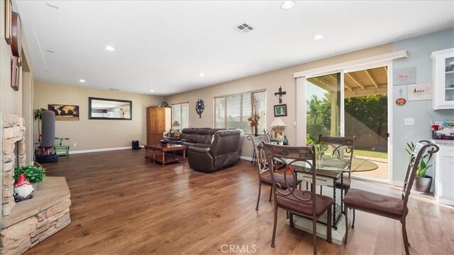 dining room featuring recessed lighting, baseboards, visible vents, and wood finished floors