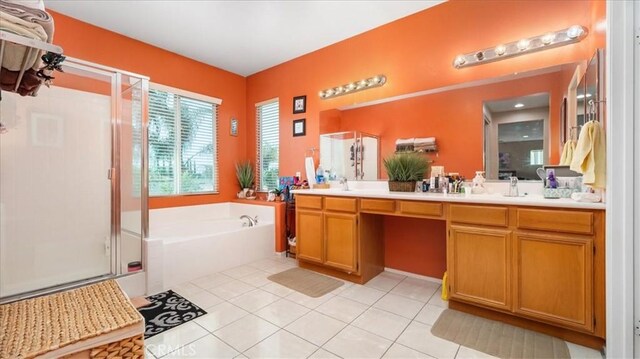 full bathroom with double vanity, a bath, tile patterned floors, a shower stall, and a sink