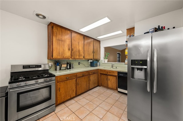 8757 San Vicente Ave, Riverside, CA 92503 - kitchen with appliances with stainless steel finishes, light countertops, brown cabinetry, decorative backsplash, and light tile patterned floors