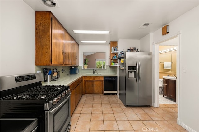 8757 San Vicente Ave, Riverside, CA 92503 - kitchen with stainless steel appliances, light countertops, brown cabinets, tasteful backsplash, and light tile patterned flooring