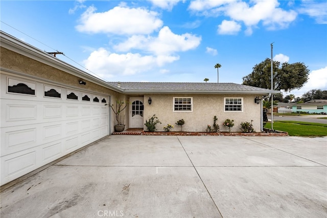 8757 San Vicente Ave, Riverside, CA 92503 - ranch-style home featuring driveway, stucco siding, and a garage