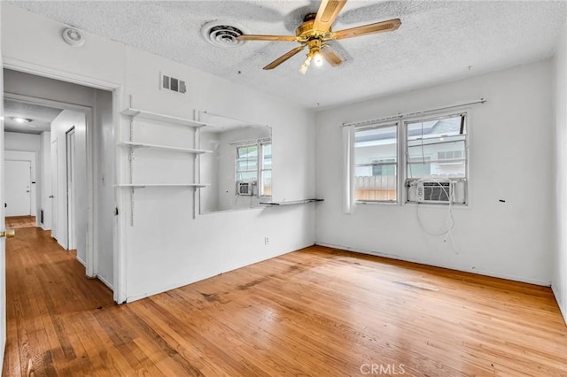 7038 Mclennan Ave, Lake Balboa, CA 91406 - empty room with cooling unit, a textured ceiling, a ceiling fan, wood finished floors, and visible vents
