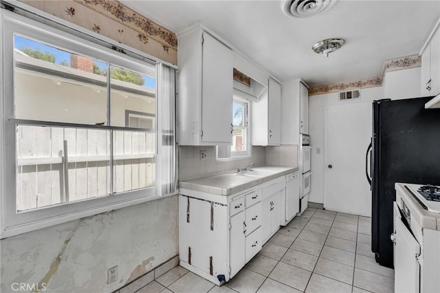 7038 Mclennan Ave, Lake Balboa, CA 91406 - kitchen featuring visible vents, white cabinetry, light tile patterned flooring, and a wealth of natural light