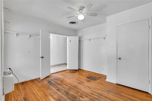 7038 Mclennan Ave, Lake Balboa, CA 91406 - unfurnished bedroom featuring hardwood / wood-style floors, ceiling fan, a textured ceiling, and visible vents