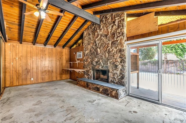 7038 Mclennan Ave, Lake Balboa, CA 91406 - unfurnished living room with ceiling fan, a fireplace, wood walls, lofted ceiling with beams, and concrete floors