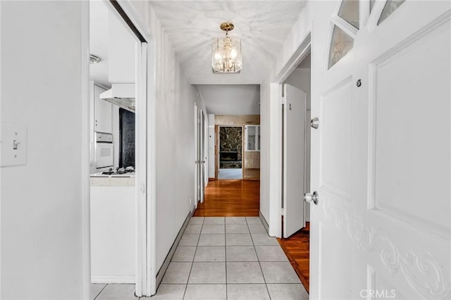 7038 Mclennan Ave, Lake Balboa, CA 91406 - hall featuring light tile patterned floors and a notable chandelier