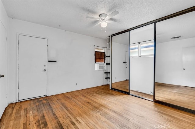 7038 Mclennan Ave, Lake Balboa, CA 91406 - unfurnished bedroom with ceiling fan, wood-type flooring, a textured ceiling, and cooling unit