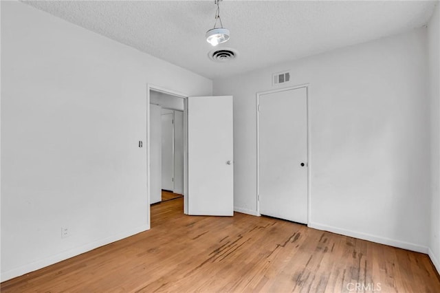 7038 Mclennan Ave, Lake Balboa, CA 91406 - unfurnished bedroom with a textured ceiling, baseboards, visible vents, and light wood-style floors
