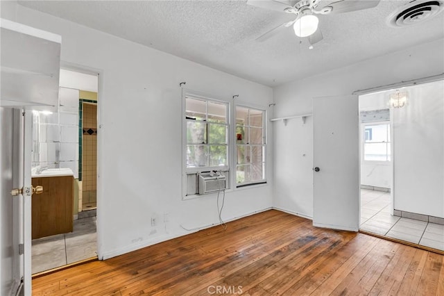 7038 Mclennan Ave, Lake Balboa, CA 91406 - unfurnished bedroom with wood-type flooring, ensuite bath, a textured ceiling, and visible vents