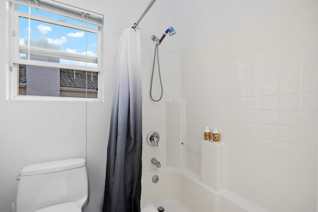 bathroom with toilet and shower / bath combination with curtain