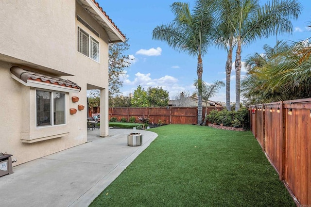 view of yard with a fenced backyard and a patio