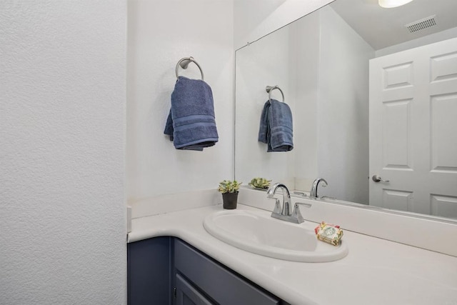 bathroom with vanity and visible vents