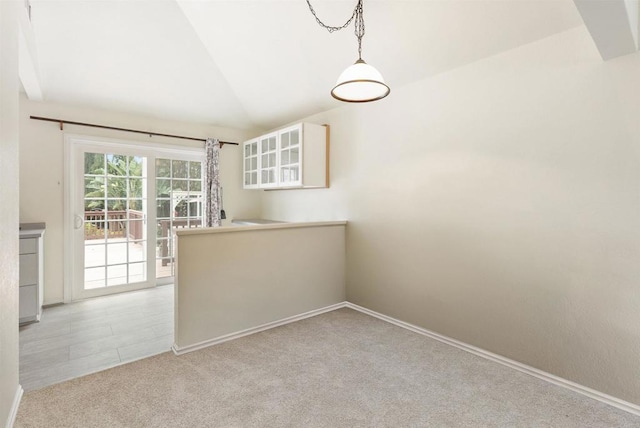 1265 Dawnridge Ave, El Cajon, CA 92021 - unfurnished dining area featuring light colored carpet, vaulted ceiling, and baseboards