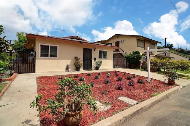 single story home with fence, a gate, and stucco siding