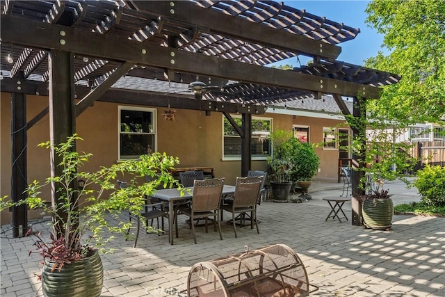 view of patio / terrace featuring a pergola, fence, and outdoor dining space