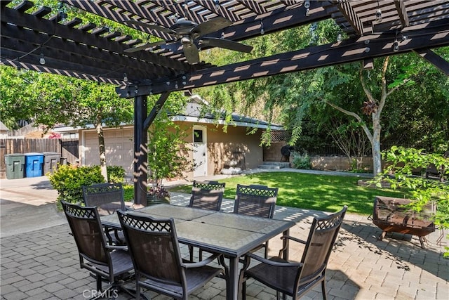 view of patio featuring ceiling fan, fence, a pergola, and outdoor dining space