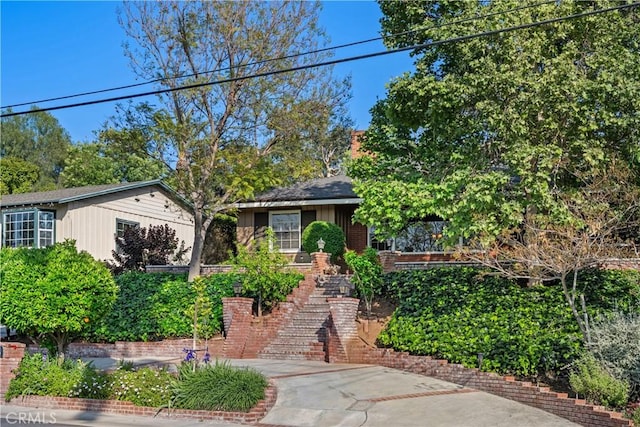 view of front of house with stairway and brick siding