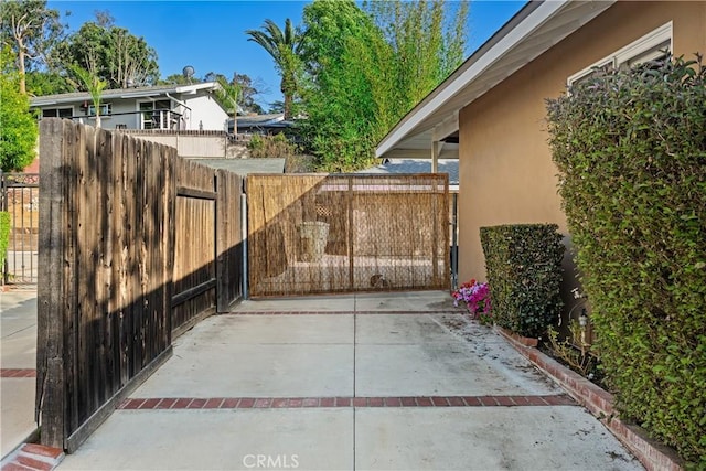 view of patio / terrace featuring fence and a gate