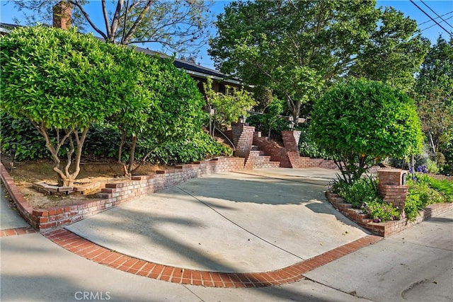 view of property's community featuring stairs and a patio area