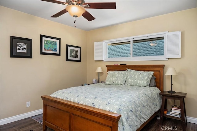bedroom with baseboards, a ceiling fan, and dark wood finished floors