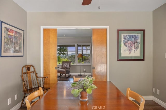 dining room with baseboards, ceiling fan, and wood finished floors