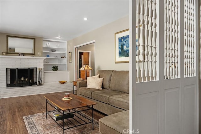 living room featuring recessed lighting, wood finished floors, and a fireplace
