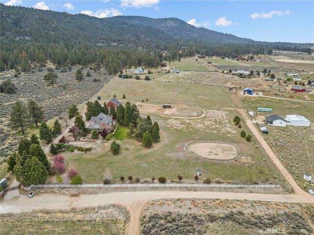 drone / aerial view with a rural view, a mountain view, and a wooded view