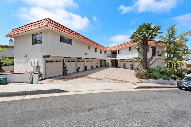 mediterranean / spanish house with stucco siding and driveway