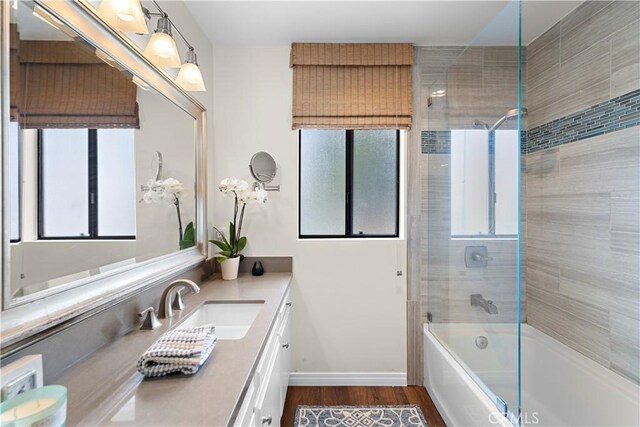 full bathroom featuring shower / bath combination, vanity, and wood finished floors