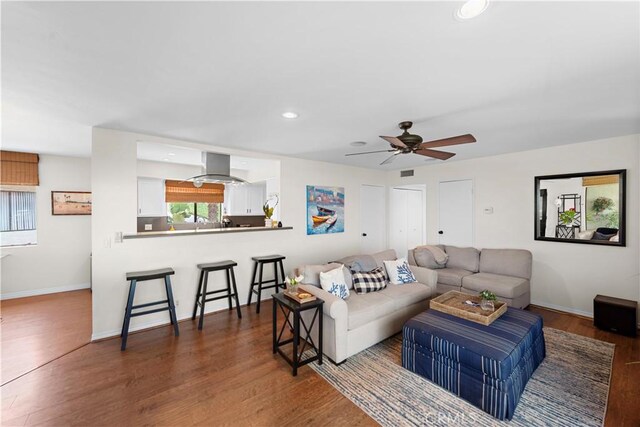 living area with recessed lighting, dark wood finished floors, ceiling fan, and baseboards
