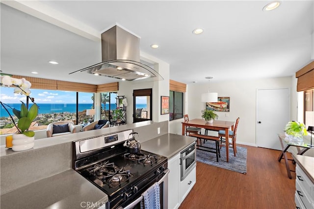 100 Calle Patricia Unit 1A, San Clemente, CA 92672 - kitchen with stainless steel gas range oven, island range hood, plenty of natural light, recessed lighting, and wood finished floors
