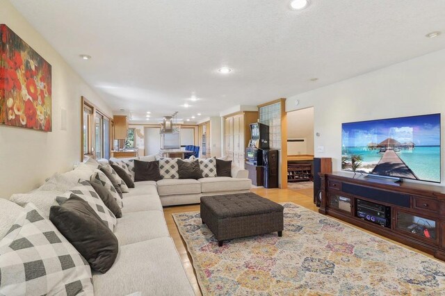 living area featuring recessed lighting and light wood-style floors