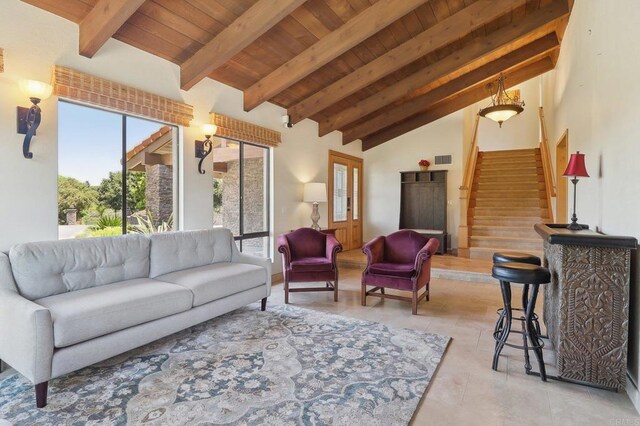 living area featuring stairs, visible vents, wooden ceiling, and vaulted ceiling with beams