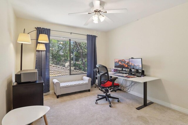 office area featuring a ceiling fan, baseboards, and carpet