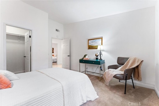 bedroom featuring light carpet, attic access, baseboards, lofted ceiling, and visible vents