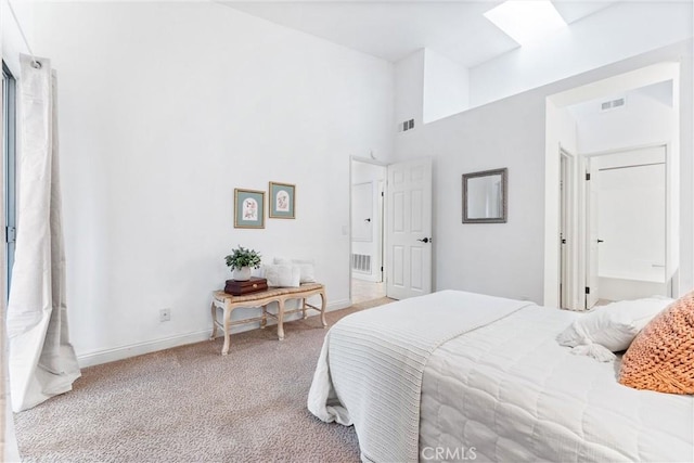 carpeted bedroom featuring visible vents, baseboards, and a high ceiling