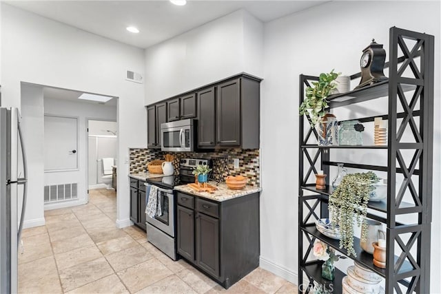 kitchen featuring visible vents, decorative backsplash, baseboards, and appliances with stainless steel finishes