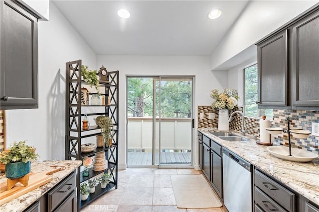 kitchen with backsplash, recessed lighting, a sink, and dishwasher