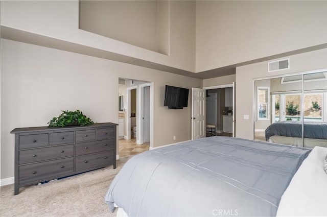 24661 Las Patranas, Yorba Linda, CA 92887 - bedroom featuring visible vents, a towering ceiling, light carpet, baseboards, and connected bathroom