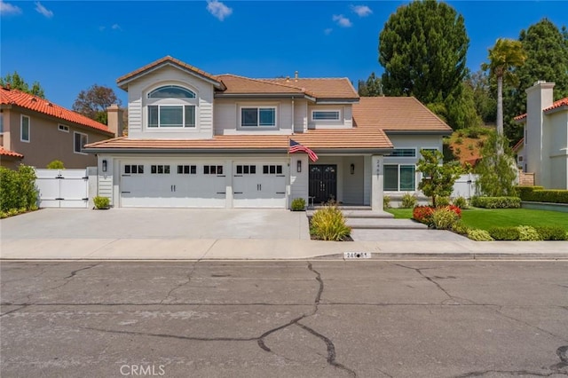 24661 Las Patranas, Yorba Linda, CA 92887 - traditional-style home featuring fence, a gate, concrete driveway, an attached garage, and a tile roof