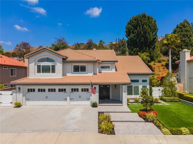 24661 Las Patranas, Yorba Linda, CA 92887 - traditional-style house featuring fence, an attached garage, a front lawn, a tile roof, and driveway