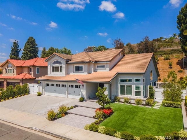 24661 Las Patranas, Yorba Linda, CA 92887 - view of front facade with a tiled roof, driveway, a garage, fence, and a front lawn