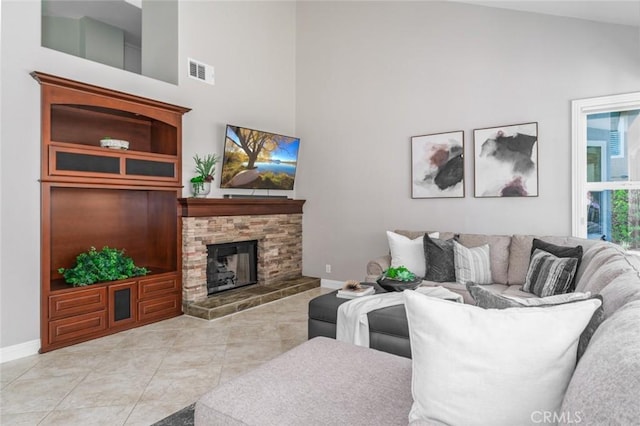 24661 Las Patranas, Yorba Linda, CA 92887 - living room with light tile patterned flooring, a stone fireplace, baseboards, a towering ceiling, and visible vents