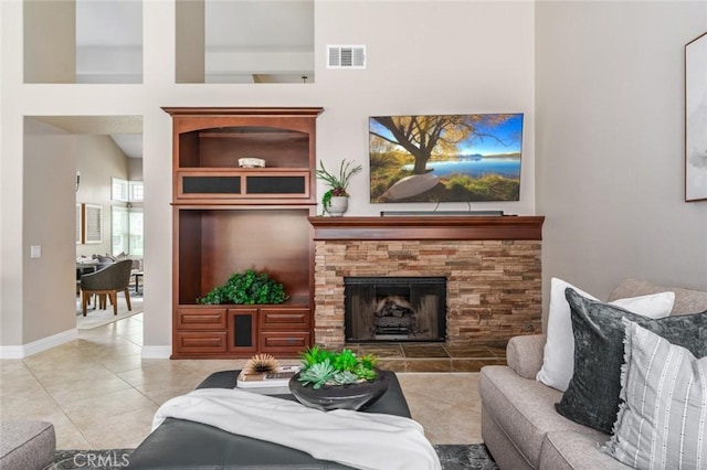24661 Las Patranas, Yorba Linda, CA 92887 - living area featuring a fireplace, tile patterned floors, baseboards, a towering ceiling, and visible vents