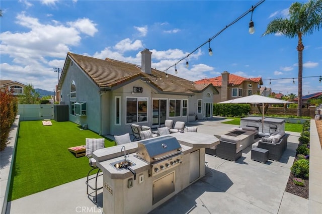 24661 Las Patranas, Yorba Linda, CA 92887 - rear view of house with area for grilling, a chimney, a fenced backyard, an outdoor living space with a fire pit, and a patio